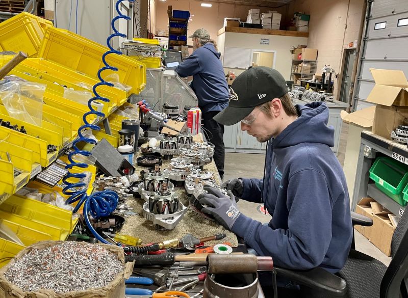 Aaron Ransavage, an assembly and test technician with American Power Systems, assembles alternators in APS’ manufacturing facility headquartered in downtown Davenport.